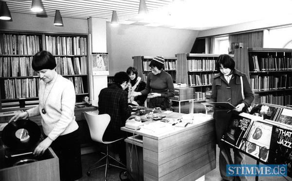 Neu ist in der Stadtücherei eine Musikabteilung im 3. Stock. Die Musikbücherei startet mit 1000 Noten 500 Büchern und 300 Schallplatten, die in Kabinen abgehört werden können. Die Leiterin ist Ursula Neumann (links) Neu ist in der Stadtücherei eine Musikabteilung im 3. Stock. Die Musikbücherei startet mit 1000 Noten 500 Büchern und 300 Schallplatten, die in Kabinen abgehört werden können. Die Leiterin ist Ursula Neumann (links)