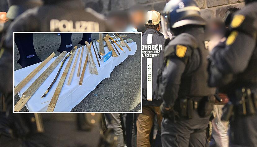 Von der Polizei gesicherte Stöcke und Latten liegen vor der Pressekonferenz zu den Ausschreitungen bei einer Eritrea-Veranstaltung auf einem Tisch (kleines Foto). Bis zu 200 Personen hätten Teilnehmer der Veranstaltung und Polizisten angegriffen, teilte ein Polizeisprecher am Samstag mit.