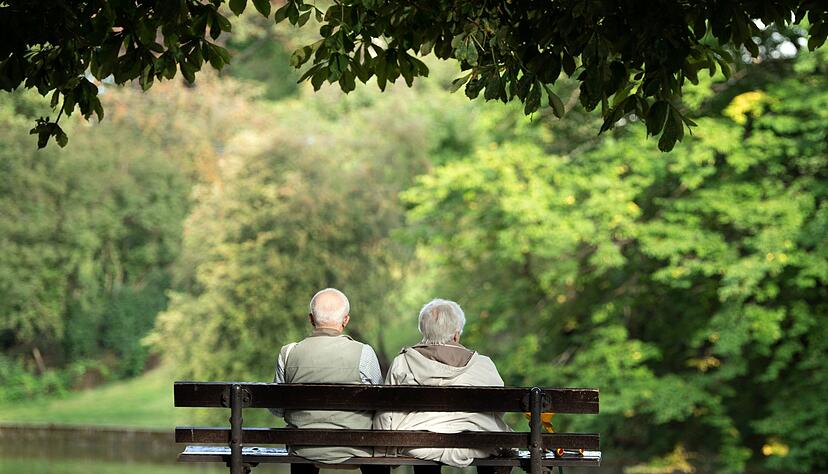 Zwei Rentner sitzen auf einer Bank.