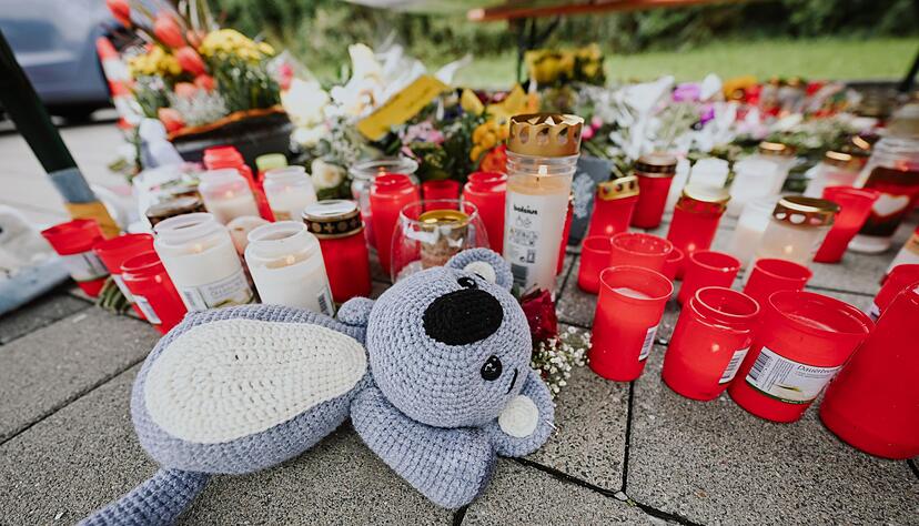 Menschen legen Blumen und Kerzen auf dem abgesperrten Parkplatz in Niedernhall nieder. Menschen legen Blumen und Kerzen auf dem abgesperrten Parkplatz in Niedernhall nieder.