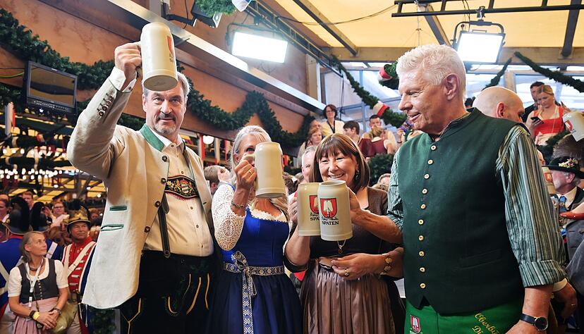 Bayerns Ministerpr&auml;sident S&ouml;der (l.) und M&uuml;nchens OB Reiter (r.) sto&szlig;en mit ihren Ehefrauen auf eine friedliche Wiesn an.
