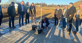 In der Bodenplatte der Lindenberghalle versenkt Bad Friedrichshalls B&uuml;rgermeister Timo Frey eine H&uuml;lse mit aktuellen Unterlagen.