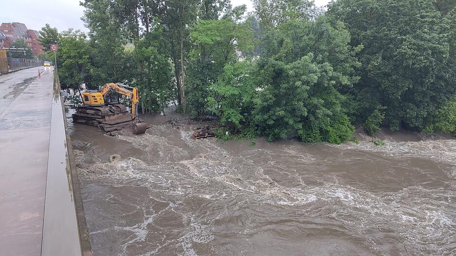 In Lauffen steht am 1. Juni 2024 auch der Bagger langsam im Wasser. Der Neckar f&uuml;hrt nach dem Dauerregen im Sommer 2024 viel Wasser.