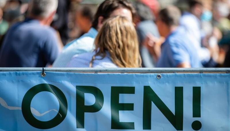 «Open» steht auf einem Banner an einem Biergarten geschrieben. «Open» steht auf einem Banner an einem Biergarten geschrieben.