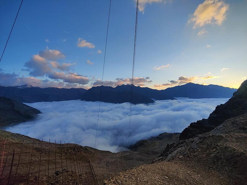 Traumhaftes Alpenpanorama: Von der Baustelle geht der Blick ins wolkenverhangene Schnalstal.