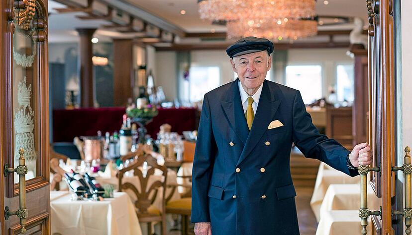 Hans-Georg Mayer mit seiner geliebten Prinz-Heinrich-Mütze am Eingang zum Schwäbischen Restaurant im Insel-Hotel.
Foto: Archiv/Berger