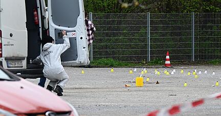 Mitarbeiterinnen der Spurensicherung der Polizei untersuchen den Tatort.