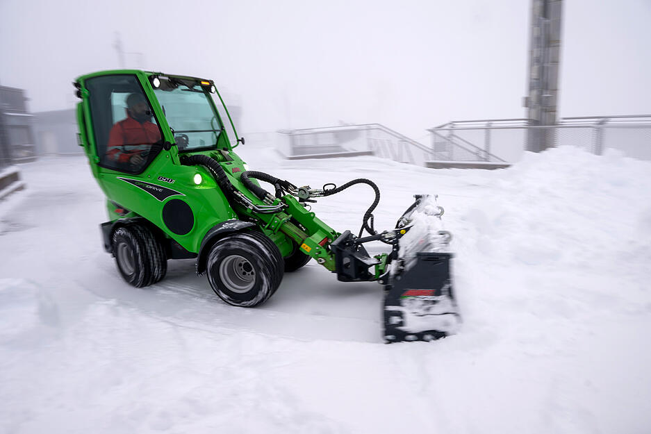 Mit einem Schneeräumer wird der Neuschnee auf der Aufsichtsplattform der Zugspitze zusammengeschoben.