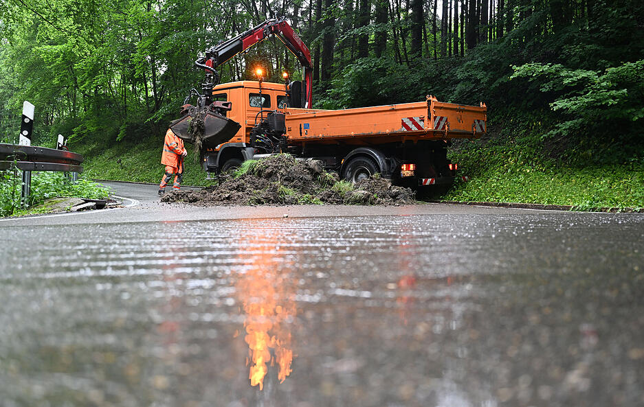 Straßenarbeiter sperren eine nach einem Unwetter unterspülte Zufahrtsstraße nach Rudersberg. Straßenarbeiter sperren eine nach einem Unwetter unterspülte Zufahrtsstraße nach Rudersberg.