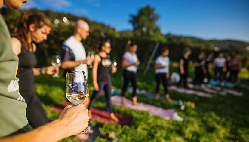 Eine Yoga-Lehrerin und das Staatsweingut in Freiburg bieten gemeinsam den Yoga-Kurs und Wein an.