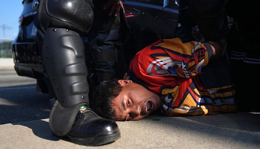 Ein Demonstrant wird festgenommen. In der Nacht hat erneut mehrere Festnahmen gegeben.