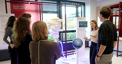 Unter anderem mit täglichen Führungen durch das Besucherzentrum bringt die Ipai-Foundation den Menschen das Thema KI näher und will Barrieren abbauen. Auf dem Foto zeigt Projektmanagerin Anna Nevobova einer Gruppe gerade den Bereich der Demonstratoren.