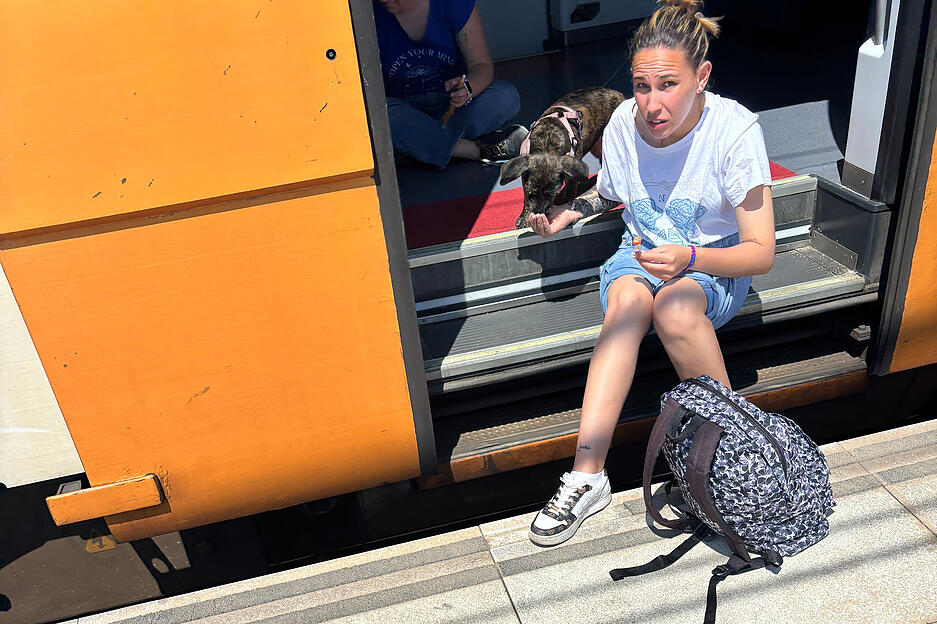 Julia und ihr Hund Lassie warten seit rund zwei Stunden, dass ihr Zug von Premia de Mar in der Provinz Barcelona aus weiterfährt.