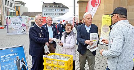 Hans Becker, Dr. Thomas Braun und OB Harry Mergel verteilen die Bäckertüten mit den Warnhinweisen an Passanten.
Foto: Ralf Seidel