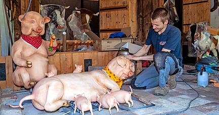 Benjamin Jung von der Werkstatt baut das Bauerntheater für den Testlauf auf. Die Figuren wie die Schweinchenfamilie sind erneuert worden.