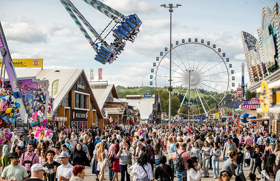23.09.2023, Baden-Württemberg, Stuttgart: genießen bei Sonnenschein das 176. Cannstatter Volksfest auf dem Cannstatter Wasen.