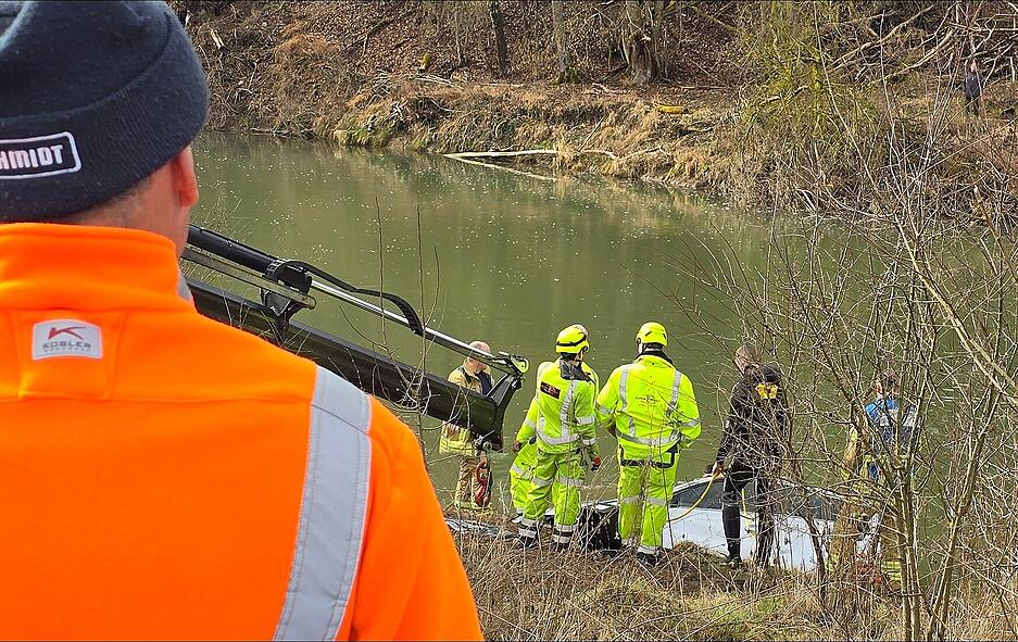 Das Wrack wurde zunächst ans Ufer der Jagst gezogen. Neben Feuerwehrkräften sind auch Bergungspezialisten der Schwabbacher Firma Florian Herbold mit Fahrzeugen im Einsatz.