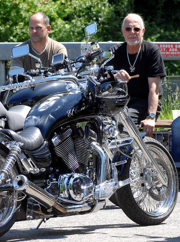 Bei einer kleinen Pause genießen Motorradfahrer das gute Wetter.