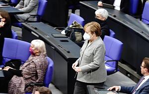 Bundeskanzlerin Angela Merkel (CDU) geht w&auml;hrend der Debatte zur &Auml;nderung des Infektionsschutzgesetzes durch den Plenarsaal.
