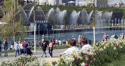 Menschen aller Generationen erkunden die Buga. Auch tagsüber gibt es am Karlssee Wasserspiele, richtig bunt wird es aber erst bei Dunkelheit. Bequem sitzen Besucher auf der Sommerinsel und genießen die musikalisch untermalten Wasserspiele.