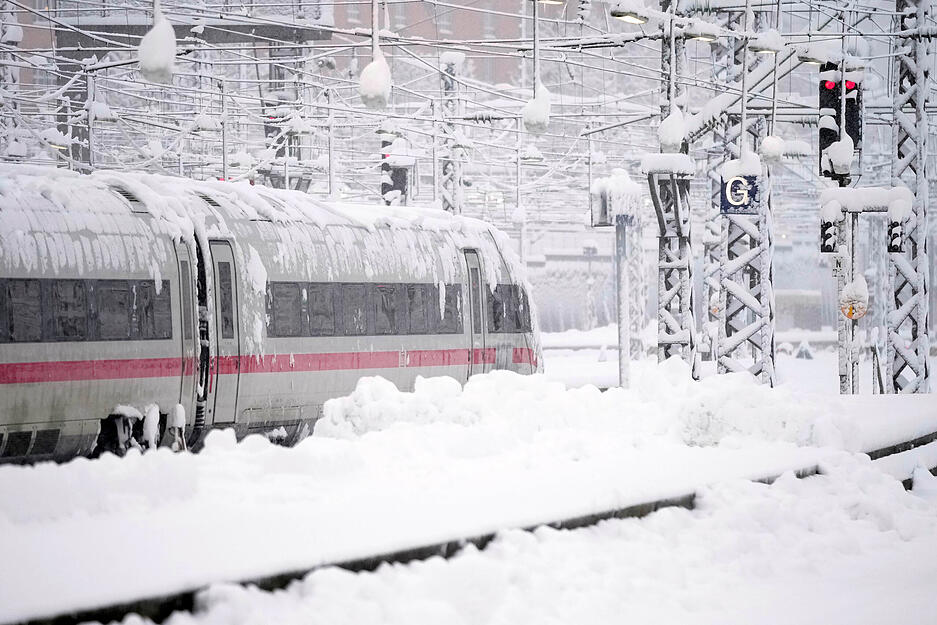 Ein ICE steht nach starkem Schneefall am Hauptbahnhof. Schnee und Eis haben im Süden Bayerns auf den Straßen und bei der Bahn für Chaos gesorgt.