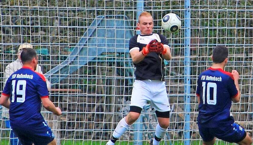 Amrichshausens Torh&uuml;ter Philipp Swoboda h&auml;lt den Kopfball von Hollenbachs Michael Kleinschrodt (rechts).Foto: Kurt Gesper