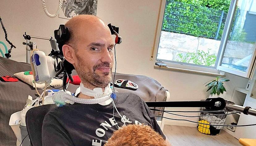 Marco Schulz hat ALS. Die Krankheit schr&auml;nkt nach und nach Bewegungsfunktionen ein. Mittlerweile kann er sich nicht mehr bewegen. Auf seinem Scho&szlig; sitzt H&uuml;ndin Lucy.
 Foto: privat