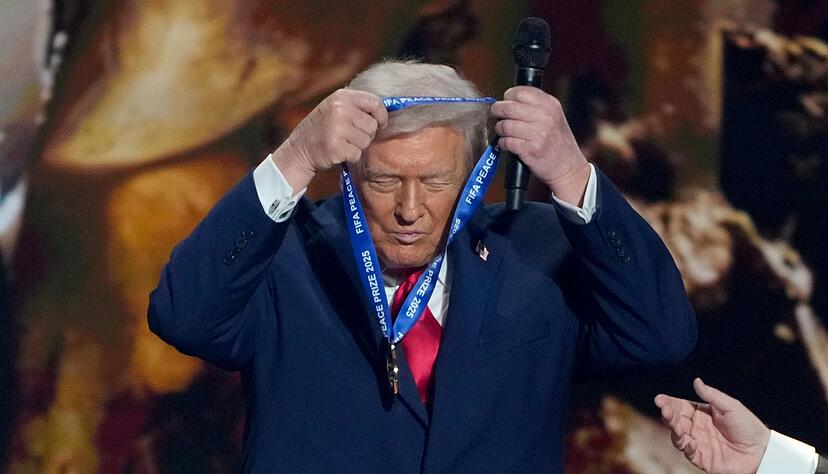 US-Präsident Trump hängt sich die FIFA-Medaille selber um. US-Präsident Trump hängt sich die FIFA-Medaille selber um.