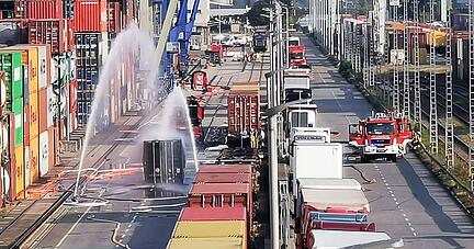 Die Feuerwehr k&uuml;hlt eine Container nach einem Chemieunfall im M&uuml;hlauhafen.