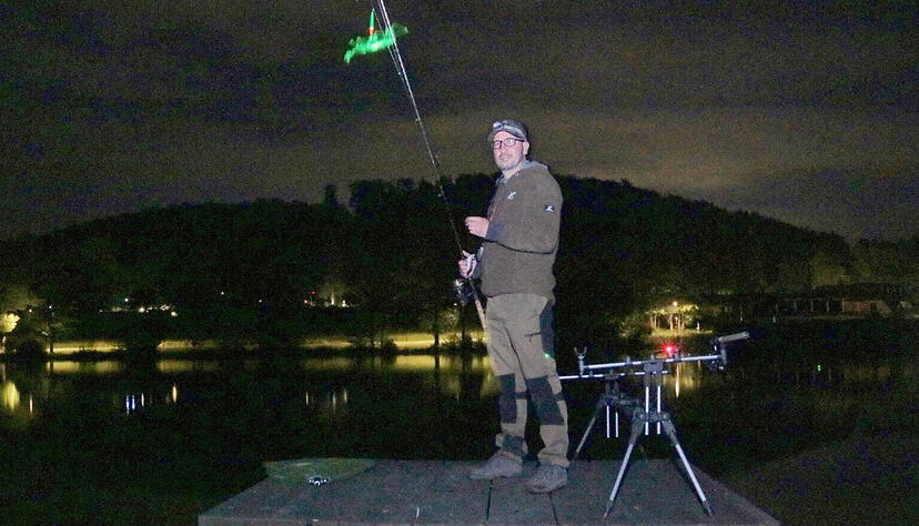 Durch ein grünes Knicklicht sieht der Vorsitzende des Angelsportclubs, Alexander Limbach, in der Nacht, wo der Haken seiner Rute im Wasser liegt − wegen der Langzeitbelichtung ist der Lichtstab am oberen Bildrand verschwommen.
Foto: Götz Greiner Durch ein grünes Knicklicht sieht der Vorsitzende des Angelsportclubs, Alexander Limbach, in der Nacht, wo der Haken seiner Rute im Wasser liegt − wegen der Langzeitbelichtung ist der Lichtstab am oberen Bildrand verschwommen.
Foto: Götz Greiner