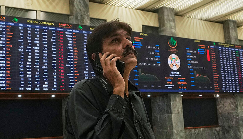 Ein Anleger betrachtet die Indizes und den Leitindex 100 an der pakistanischen Börse (PSE).