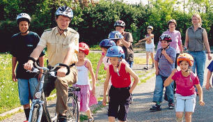 Erst mal alles begutachten: Polizeiobermeister Bernhard Engelhardt zeigt den Kindern die Strecke, bevor sie selbst aufs Rad dürfen.Foto: Stefanie Pfäffle Erst mal alles begutachten: Polizeiobermeister Bernhard Engelhardt zeigt den Kindern die Strecke, bevor sie selbst aufs Rad dürfen.Foto: Stefanie Pfäffle