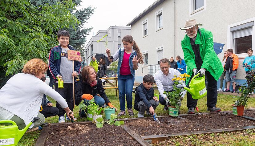 Startschuss f&uuml;r den Mitmachgarten: Auch die Kinder und Erzieherinnen von Meseno sind dabei und g&auml;rtnern mit Hans Hamb&uuml;cher (re.) und Dominik Buchta.
Fotos: Mario Berger