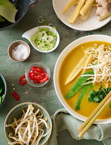 Leuchtendes Gelb und knackiges Gr&uuml;n tritt auf Kokosmilch und Babymais: Diese thail&auml;ndische Gem&uuml;sesuppe bringt einen Hauch Fernost in die Suppensch&uuml;ssel.