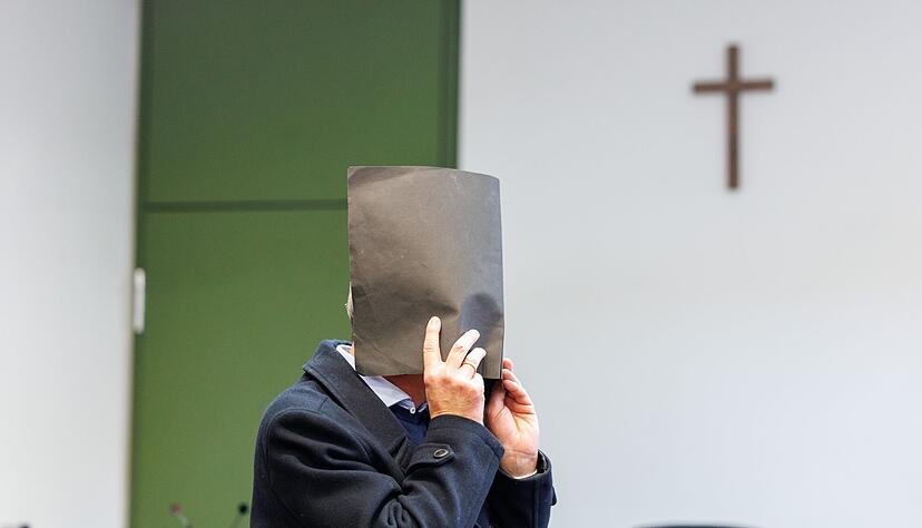 Der Angeklagte versteckte zu Prozessbeginn sein Gesicht. Er bestreitet die Vorw&uuml;rfe.