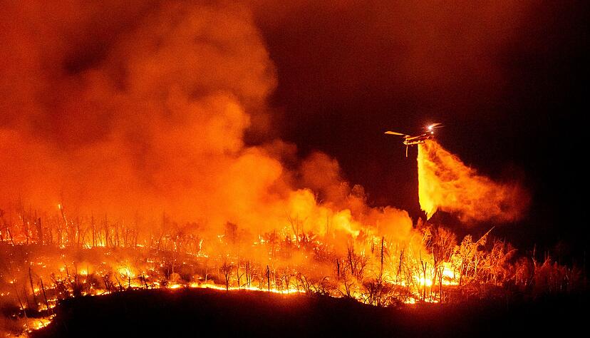 Ein Hubschrauber wirft Wasser auf das Thompson-Feuer Ein Hubschrauber wirft Wasser auf das Thompson-Feuer