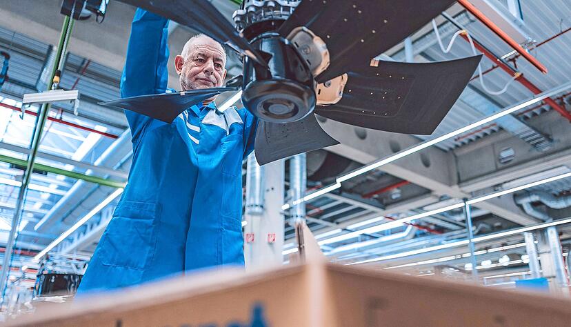 Ein Mitarbeiter in Hollenbach verpackt einen gro&szlig;en Ventilator. &Uuml;ber Sensoren k&ouml;nnen die Motoren &uuml;berwacht und damit intelligent gesteuert werden.
EBM-Papst