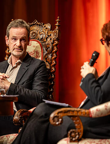 „Ein bisschen Hybris muss man ja haben, wenn man die Schnapsidee hat, diesen Beruf zu ergreifen“: Schauspieler Jörg Hartmann plauderte am Montagabend mit Moderatorin Bernadette Schoog.