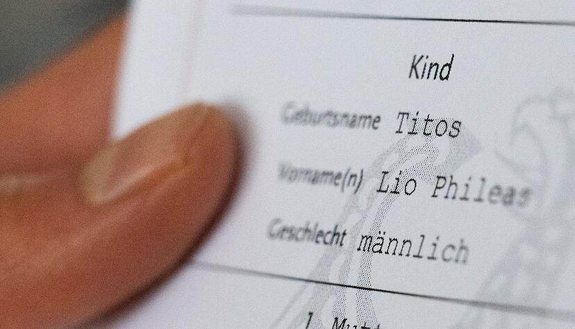 Lio Titos h&auml;lt seine Geburtsurkunde in der Hand.