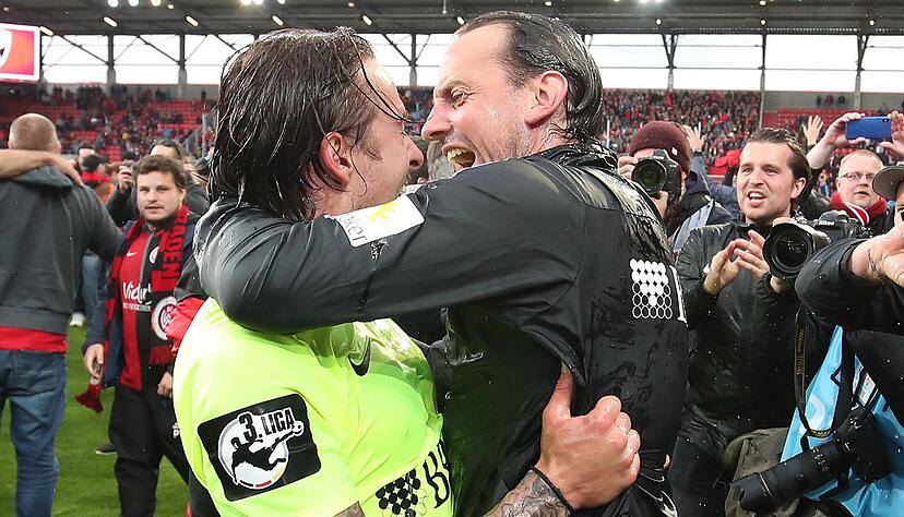 Moritz Kuhn von Wiesbaden (l) jubelt mit seinem Trainer R&uuml;diger Rehm &uuml;ber den Sieg und den Aufstieg der Mannschaft in die 2. Bundesliga. Foto: dpa