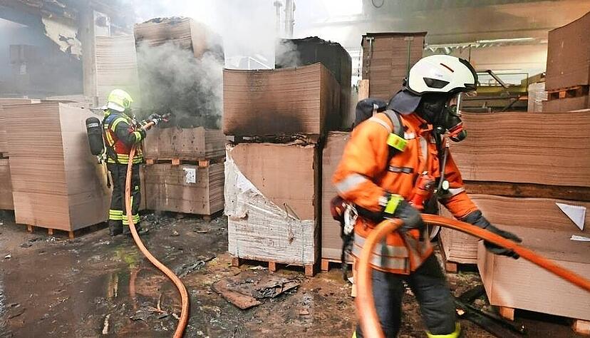 Das Feuer im Lager ist rasch unter Kontrolle und gelöscht: Die Angriffstrupps der Feuerwehr bekämpfen danach noch letzte Glutnester.