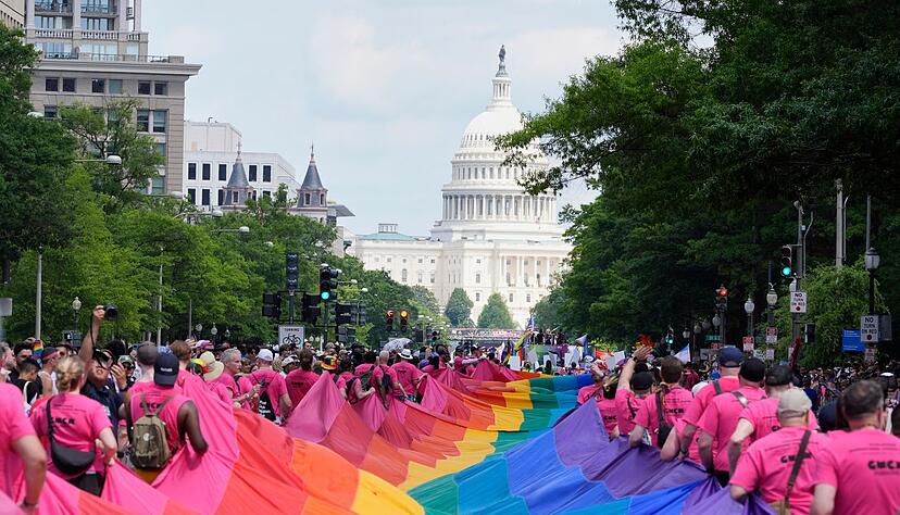 Mit riesigen Regenbogenfahnen demonstrieren Menschen mit Blick auf das US-Kapitol bei einer Pride-Parade in Washington für die Rechte der LGBTQI+-Gemeinschaft. Mit riesigen Regenbogenfahnen demonstrieren Menschen mit Blick auf das US-Kapitol bei einer Pride-Parade in Washington für die Rechte der LGBTQI+-Gemeinschaft.