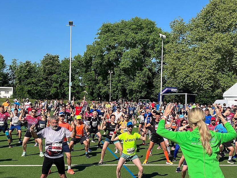 Sporttherapeutin Sabine, Sonntag von der AOK leitet das Aufwärmprogramm. „So einen Lauf ohne Aufwärmen einzugehen, ist keine gute Idee“, sagt sie. Zehn Minuten dauert das Programm.