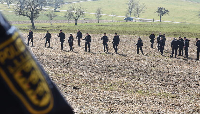 Einsatzkräfte der Polizei suchen ein Gebiet ab. Einsatzkräfte der Polizei suchen ein Gebiet ab.