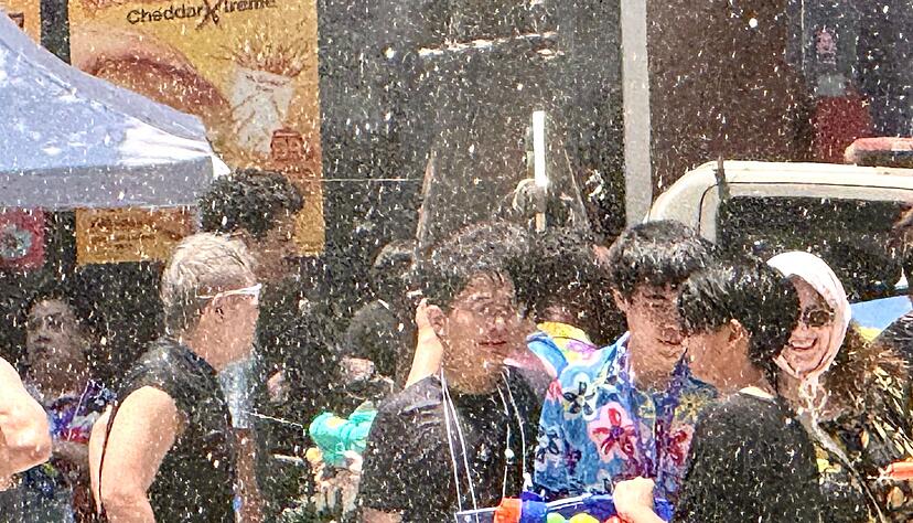 Einheimische und Touristen feiern traditionell zusammen - die meisten sind nach wenigen Minuten klatschnass.