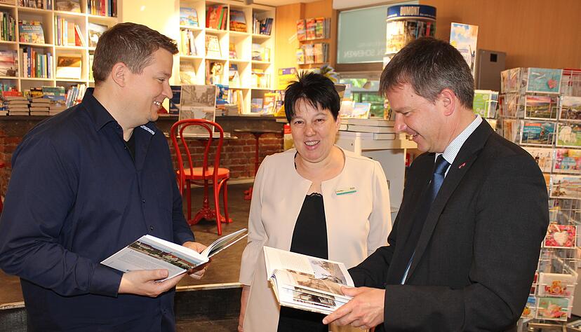 Zusammen mit Markus Hassler (links) überreicht die Autorin und Buchhändlerin ein Exemplar ihres Bildbands an Rathauschef Thilo Michler
Foto: Regina Koppenhöfer.