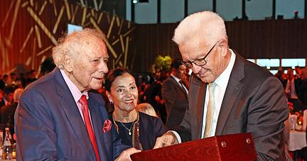 Ministerpr&auml;sident Winfried Kretschmann hat zum 70. Arbeitsjubil&auml;um von Reinhold W&uuml;rth, dem "Mann mit der einzigartigen Erfolgsgeschichte", Wein und den Dank des Landes mitgebracht. Im Hintergrund Ehefrau Carmen W&uuml;rth. 
Fotos: Ralf Seidel