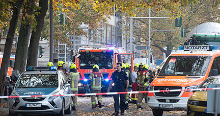 Einsatzfahrzeuge von Polizei und Feuerwehr stehen an der Bundesallee in Berlin-Wilmersdorf, wo eine Radfahrerin bei dem Verkehrsunfall mit einem Lastwagen lebensgefährlich verletzt wurde.