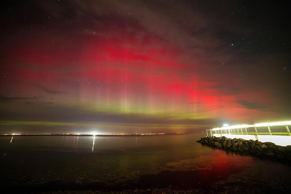 Polarlichter leuchten über der Lübecker Bucht,rechts im Bild ist die Seebrücke Niendorf zu sehen. Nach Angaben des amerikanischen Atmosphärendienstes NOAA gab es einen leichten Sonnensturm.
