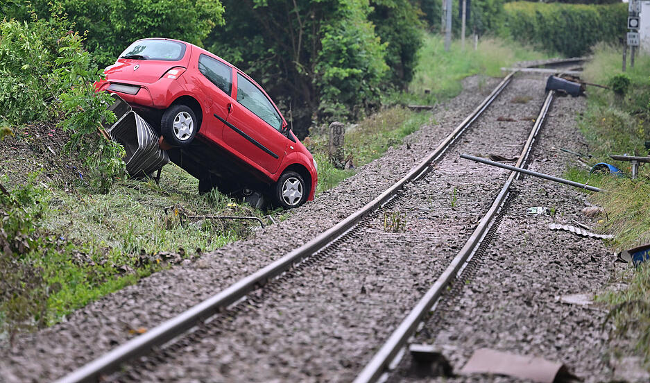 An Bahngleisen in Rudersberg steht ein durch ein Hochwasser weggespültes Auto. An Bahngleisen in Rudersberg steht ein durch ein Hochwasser weggespültes Auto.